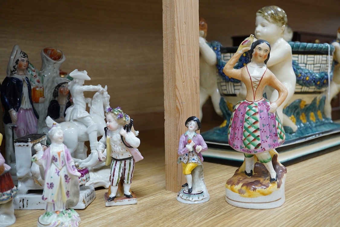 A collection of 19th century porcelain and ceramic figures, mostly Staffordshire, largest 28cm high